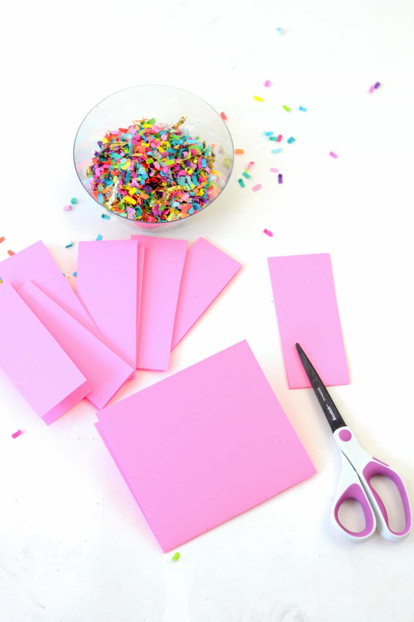 Folded pink piece of paper cut into strips