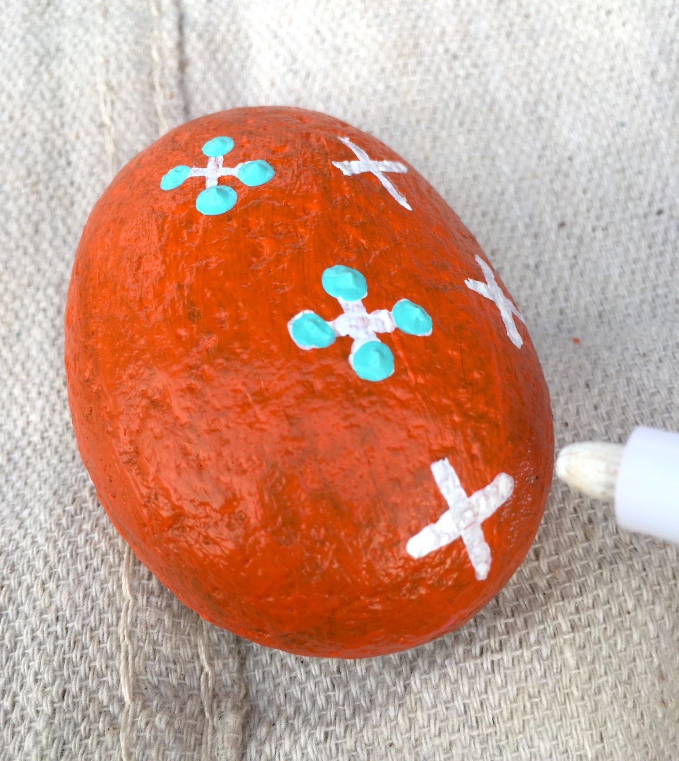 Adding details to a rock with a paint pen